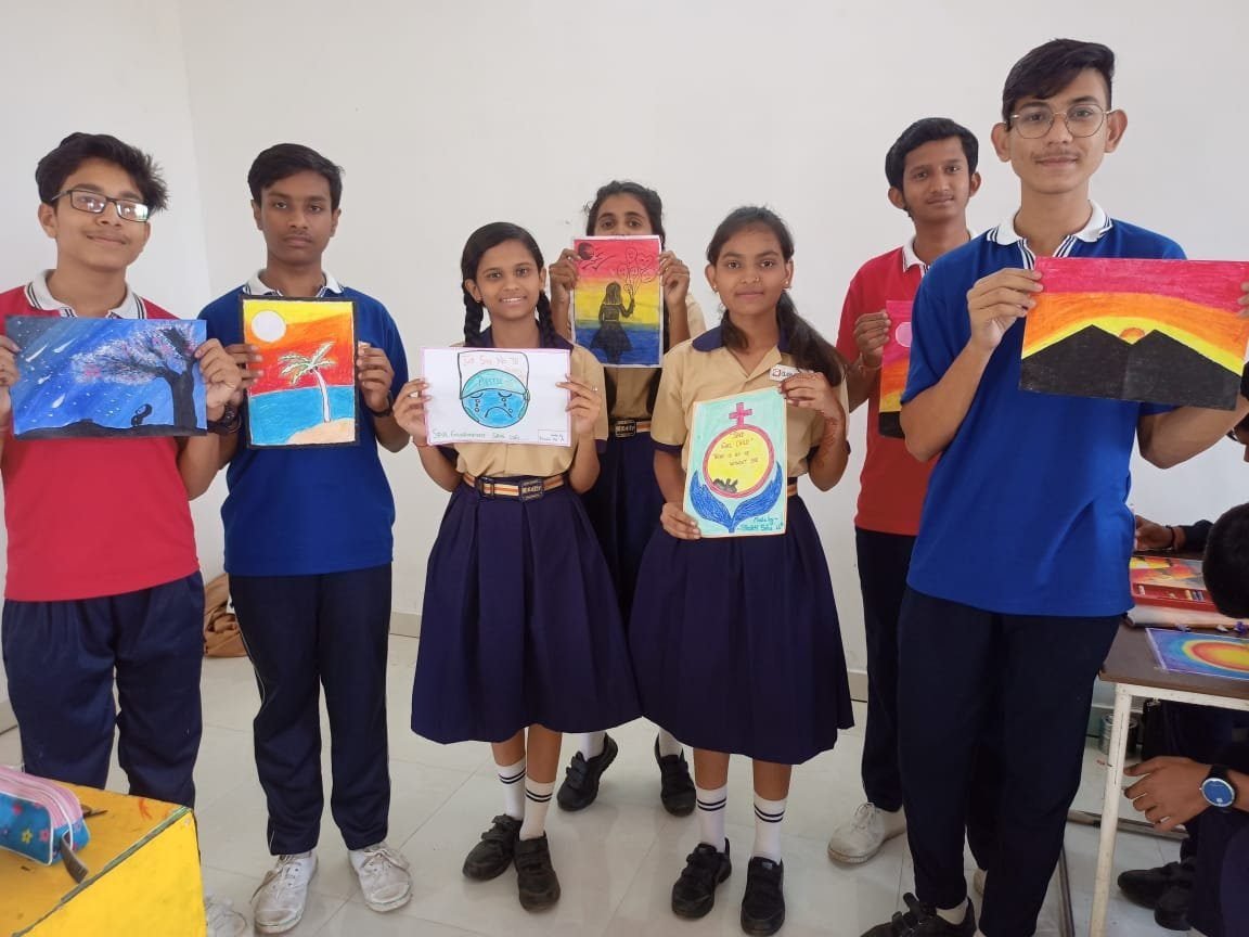 Students with their artwork